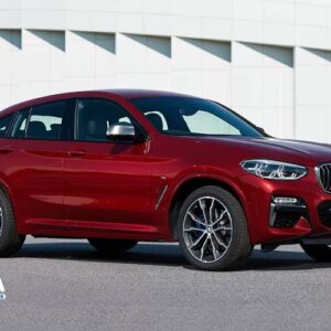 A red BMW X4 2019 standing front side