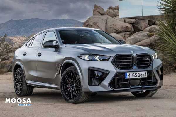 Grey BMW X6 M Competition standing in sands